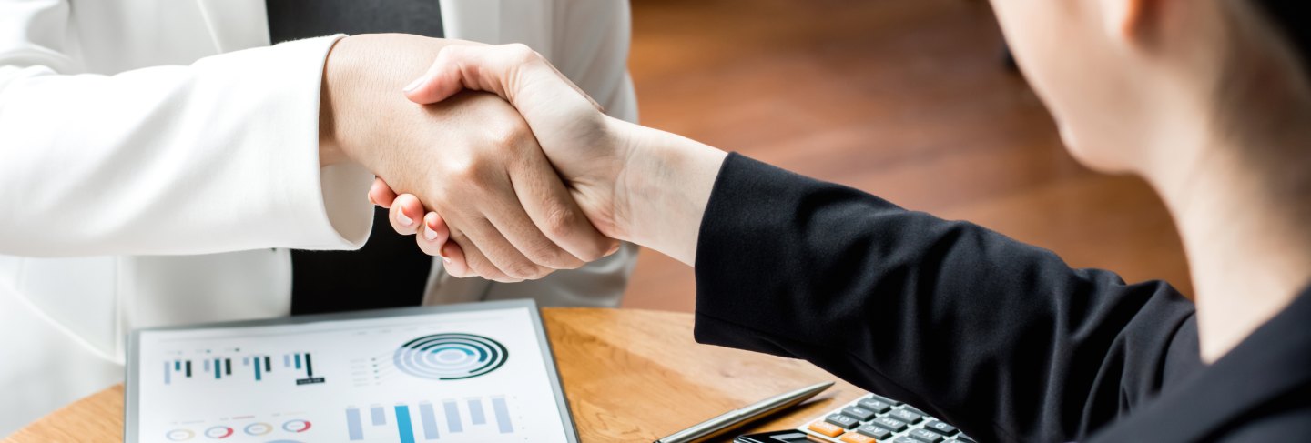 Businesswoman leaders making handshake in the office lounge
