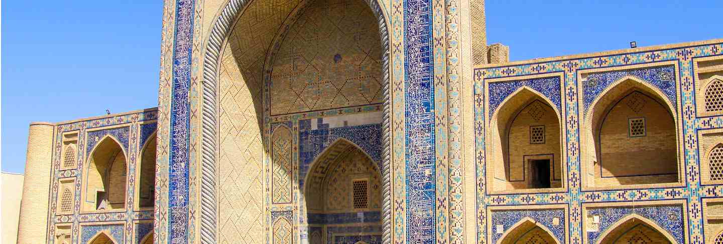 Side view of ulugbek medressa, the oldest madrasah of central asia, in bukhara, uzbekistan.
