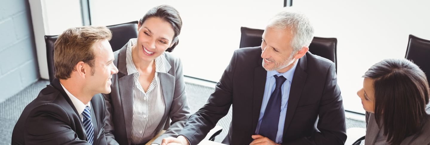 Business men shaking hands in conference room
