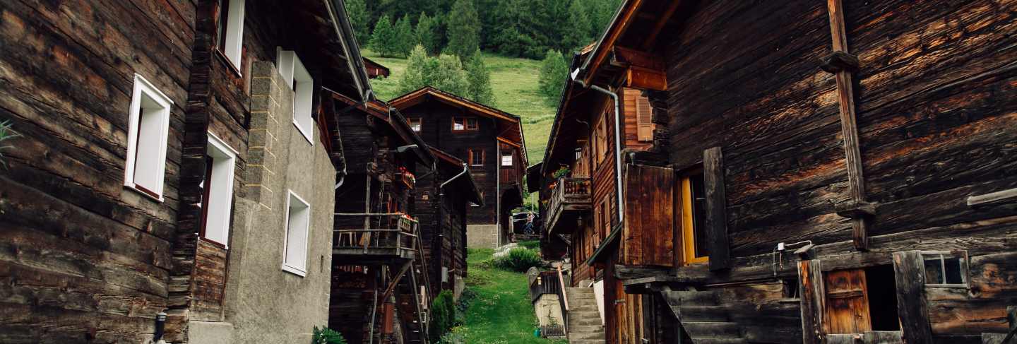 Traditional swiss village with old wooden houses in alps
