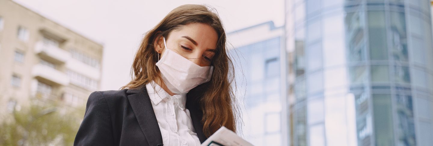 Businesswoman standing outdoors in city office building 
